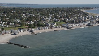 AX91_120 - 4K aerial stock footage of flying by beachfront homes in a coastal neighborhood in Stratford, Connecticut