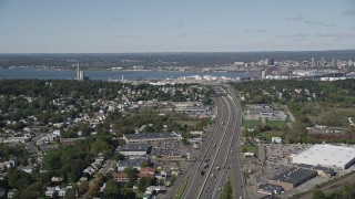 4K aerial stock footage of flying by Connecticut Turnpike freeway with view of an oil refinery, New Haven, Connecticut Aerial Stock Footage | AX91_141