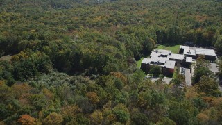 4K aerial stock footage flyby Abraham Baldwin Middle School and over forest, autumn, Guilford, Connecticut Aerial Stock Footage | AX91_174