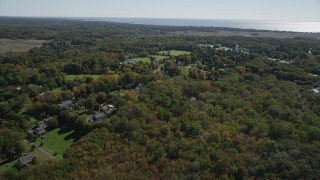 AX91_185 - 4K aerial stock footage fly over forest, approach suburban neighborhoods in autumn, Guilford, Connecticut