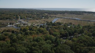 4K aerial stock footage of flying over rural neighborhoods while approaching a river in autumn, Guilford, Connecticut Aerial Stock Footage | AX91_187