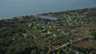 4K aerial stock footage of flying by upscale homes in a coastal neighborhood, Southold, New York Aerial Stock Footage | AX91_202