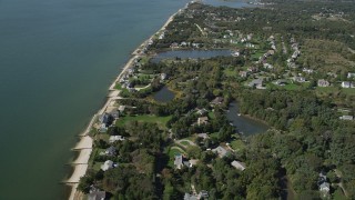 4K aerial stock footage of flying by upscale homes in a coastal neighborhood, Southold, New York Aerial Stock Footage | AX91_203