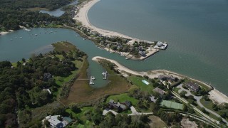 4K aerial stock footage of flying by beachfront homes by Wooley Pond, Southampton, New York Aerial Stock Footage | AX91_206