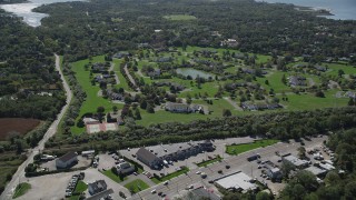 4K aerial stock footage of approaching upscale homes and a pond in Southampton, New York Aerial Stock Footage | AX91_208