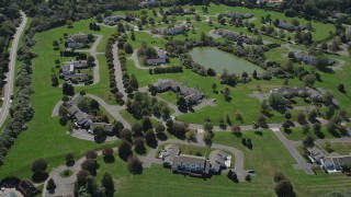 4K aerial stock footage of flying over upscale homes near a small pond in Southampton, New York Aerial Stock Footage | AX91_209