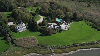 AX91_214 - 4K aerial stock footage of passing two mansions near the water, Southampton, New York