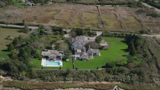 AX91_215 - 4K aerial stock footage of approaching a mansion with a pool in Southampton, New York