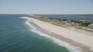 4K aerial stock footage of a row of beachfront mansions and a car parked on the beach, Southampton, New York Aerial Stock Footage | AX91_227