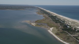 4K aerial stock footage of flying away from beach and coastal homes by Shinnecock Bay, Southampton, New York Aerial Stock Footage | AX91_231