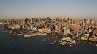 AX93_004 - 4K aerial stock footage Flying by Chelsea Piers, Hudson River, New York, New York, sunset