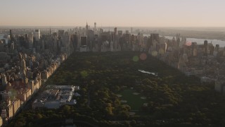 AX93_021 - 4K aerial stock footage Jacqueline Kennedy Onassis Reservoir, Central Park, Midtown, New York, sunset