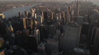 4K aerial stock footage Flying by Midtown Manhattan skyscrapers, tilt down, New York, New York, sunset Aerial Stock Footage | AX93_029