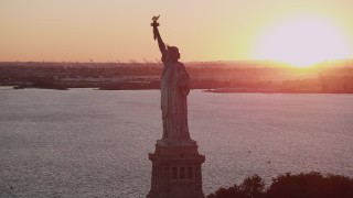 4K aerial stock footage Flying by the Statue of Liberty, New York Harbor, New York, New York, sunset Aerial Stock Footage | AX93_111