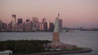 4K aerial stock footage Flying by Statue of Liberty, Lower Manhattan skyline, New York, sunset Aerial Stock Footage | AX93_120