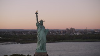 4K aerial stock footage Flying by the Statue of Liberty, New York, New York, sunset Aerial Stock Footage | AX93_121