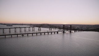 4K aerial stock footage of Newark Bay Bridge, Lehigh Valley Railroad Bridge, Newark Bay, Newark, New Jersey, twilight Aerial Stock Footage | AX93_127