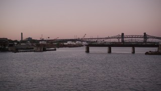 AX93_131 - 4K aerial stock footage of Industrial buildings, Lincoln Highway Bridge, Pulaski Skyway Bridge, Newark, New Jersey, twilight