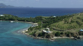 5k stock footage aerial stock footage orbiting American flag and pool area on Little St James Island, St Thomas, Virgin Islands Aerial Stock Footage | AX96_162