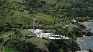 5k stock footage aerial stock footage orbiting flag and pool and fly away on Little St James Island, St Thomas, Virgin Islands Aerial Stock Footage | AX96_163