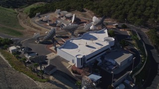 AXSF01_006 - 5K aerial stock footage of flying by satellite dishes in the hills, Fillmore, California