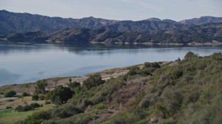 5K aerial stock footage of flying over a wooded hillside, revealing Lake Casitas, California Aerial Stock Footage | AXSF01_016