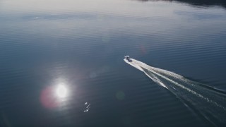 5K aerial stock footage of tracking a fishing boat cruising on the lake, Lake Casitas, California Aerial Stock Footage | AXSF01_022