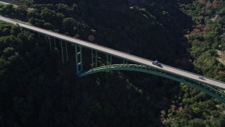 AXSF01_039 - 5K aerial stock footage of flying by Cold Springs Canyon Arch Bridge, Santa Ynez Mountains, California