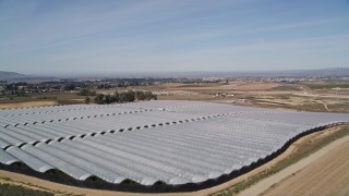 5K aerial stock footage of flying over farm fields, approaching greenhouses, Santa Maria, California Aerial Stock Footage | AXSF02_001