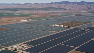 AXSF02_002 - 5K aerial stock footage of flying by farm fields with crops, wide view of the rural landscape, Santa Maria, California