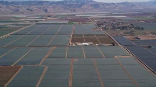 AXSF02_003 - 5K aerial stock footage of flying by a rural landscape of crop fields, Santa Maria, California