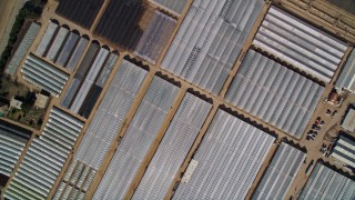 AXSF02_010 - 5K aerial stock footage Bird's eye view over dry riverbed, reveal greenhouses and farmland, Nipomo, California