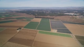 5K aerial stock footage tilt up and fly over geometric farmland, Nipomo, California Aerial Stock Footage | AXSF02_011