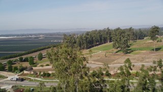 5K aerial stock footage of flying over a small forest, revealing crop fields, Nipomo, California Aerial Stock Footage | AXSF02_013