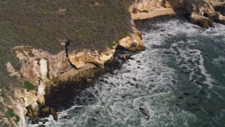 5K aerial stock footage of flying by ocean waves rolling into coastal cliffs, San Luis Obispo, California Aerial Stock Footage | AXSF02_038