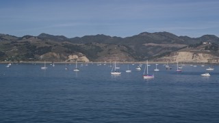 5K aerial stock footage of flying low by sailboats in San Luis Obispo Bay, Avila Beach, California Aerial Stock Footage | AXSF02_041