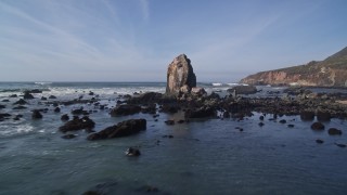 5K aerial stock footage of flying low past rock formations off the coast, Avila Beach, California Aerial Stock Footage | AXSF02_054