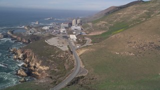 AXSF02_056 - 5K aerial stock footage fly low beside the coast, reveal Diablo Canyon Power Plant, Avila Beach, California