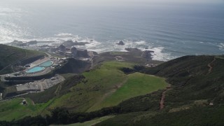 AXSF02_064 - 5K aerial stock footage flyby hills to reveal the Diablo Canyon Power Plant nuclear facility, Avila Beach, California