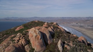 5K aerial stock footage tilt from bay, reveal Morro Rock, Morro Strand State Beach, Morro Bay, California Aerial Stock Footage | AXSF03_003