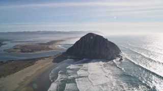 AXSF03_010 - 5K aerial stock footage of flying by Dynegy Power Plant, Morro Rock, coast, harbor in Morro Bay, California