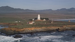 5K aerial stock footage of passing by Point Piedras Blancas lighthouse, San Simeon, California Aerial Stock Footage | AXSF03_056