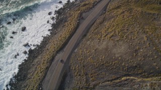 5K aerial stock footage of tracking a car traveling on Highway 1 along the coast, Big Sur, California Aerial Stock Footage | AXSF03_074