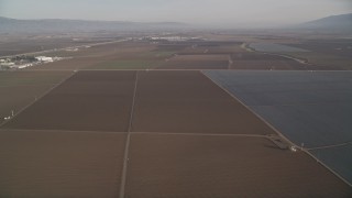 5K aerial stock footage of flying by a landscape of vast farm fields, Salinas, California Aerial Stock Footage | AXSF03_114