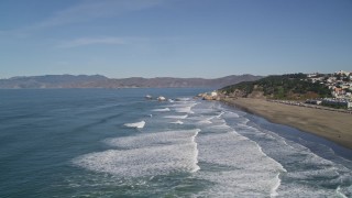 AXSF05_055 - 5K aerial stock footage fly over crashing ocean waves, approach Seal Rocks and Ocean Beach, Outer Richmond District, California