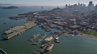 AXSF05_064 - 5K aerial stock footage flyby Fisherman's Wharf, approach Pier 39, San Francisco, California