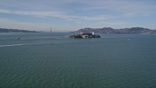 AXSF05_066 - 5K aerial stock footage of iconic Alcatraz with a view of the famous Golden Gate Bridge, San Francisco, California