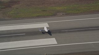 5K aerial stock footage tracking small plane landing at Oakland International Airport, Oakland, California Aerial Stock Footage | AXSF05_091