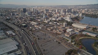 5K aerial stock footage tilt from I-880 freeway and train yard to reveal Downtown Oakland, California Aerial Stock Footage | AXSF06_005