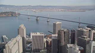 AXSF06_022 - 5K aerial stock footage of a bird's eye view of California Street in the city's Chinatown district, tilt to reveal Bay Bridge, San Francisco, California